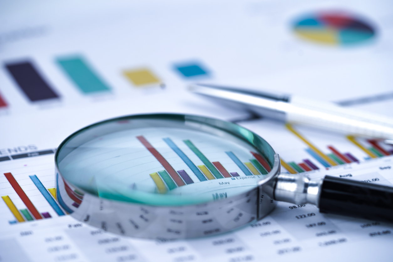 Image of a Magnifying glass on charts graphs spreadsheet paper. Financial development, Banking Account, Statistics, Investment Analytic research data economy, Stock exchange trading, Business office company meeting concept.