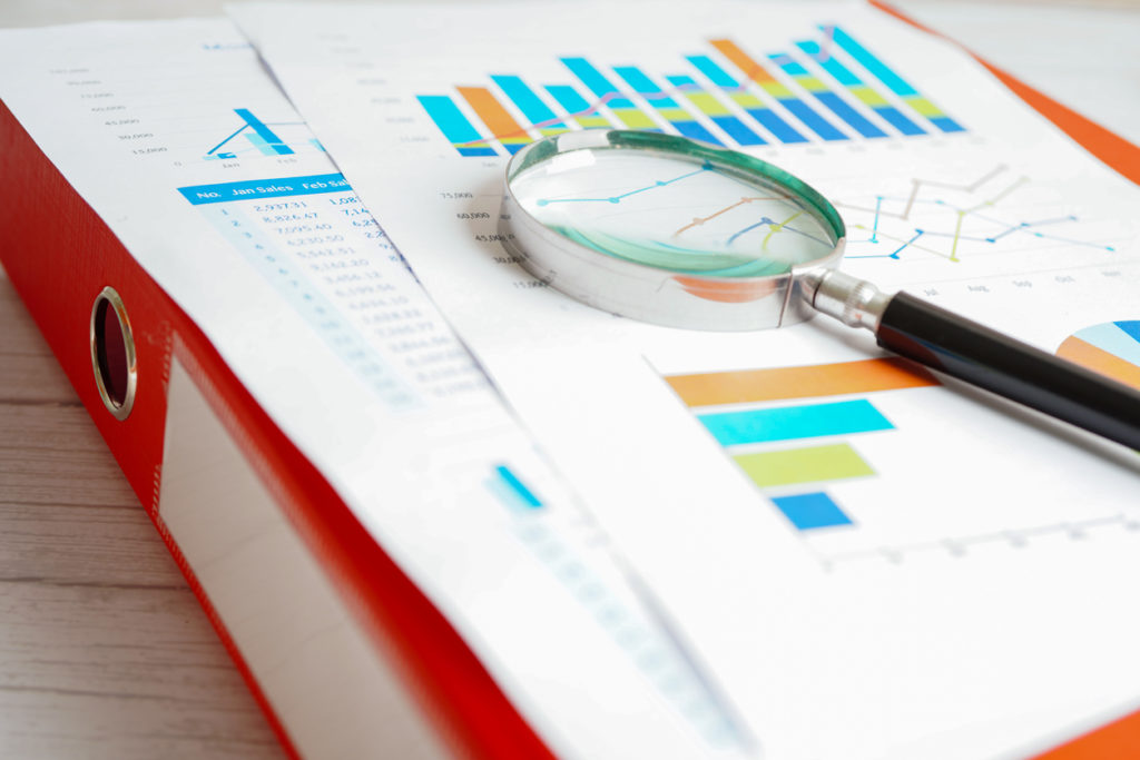 Image of magnifying glass on charts graphs paper. Financial development, Banking Account, Statistics, Investment Analytic research data economy.