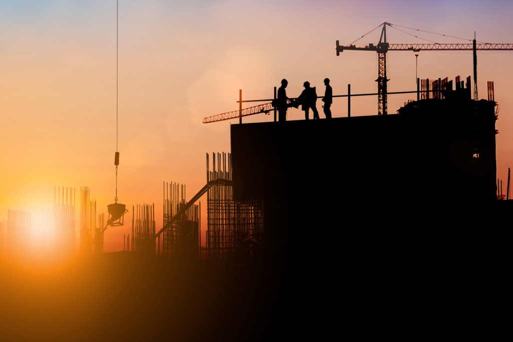 Image of Silhouette of engineer and construction team working at site over blurred background for industry background.