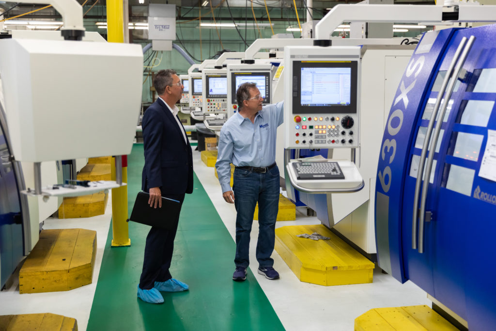 Image of workers at a CNC machine shop.