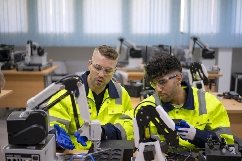 Image of Technician working with robotic arm.