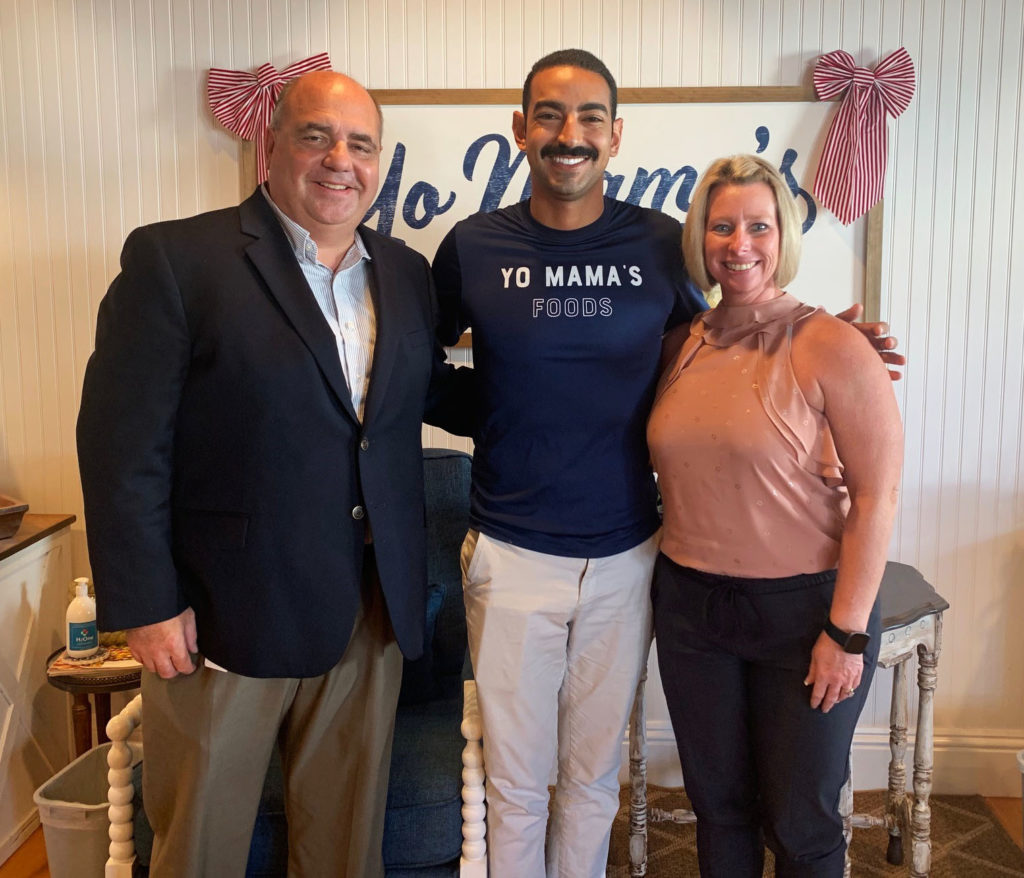 Image of Brent Brent Barkway, Business Development Manager with Pinellas County Economic Development, David Habib, Founder of Yo Mama's Foods, and Stephanie Scalos, Business Retention & Expansion Coordinator, City of Clearwater in an office.
