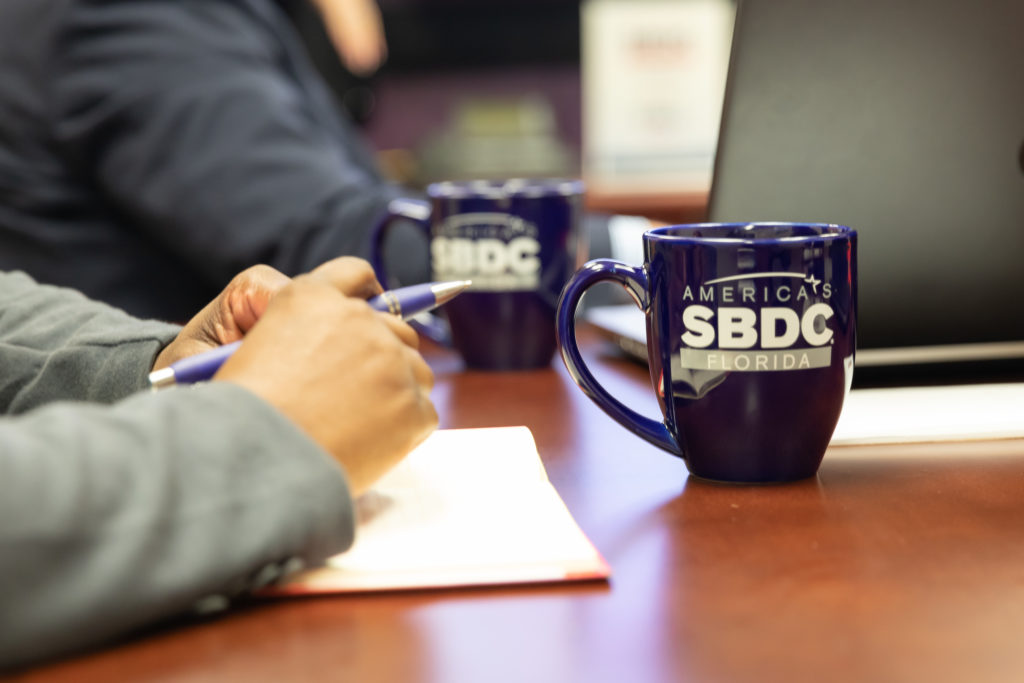 Image of SBDC branded mugs on a table.
