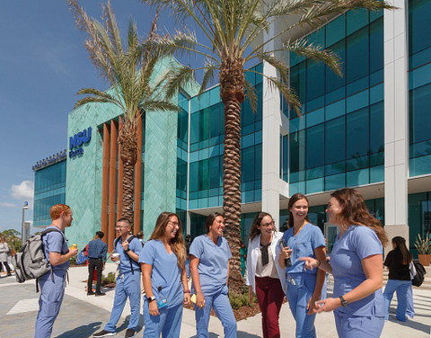 Image of medical students standing and talking in front of Nova University in Clearwater, Florida.