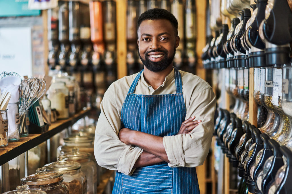 Shot of a young male business owner in his grocery store