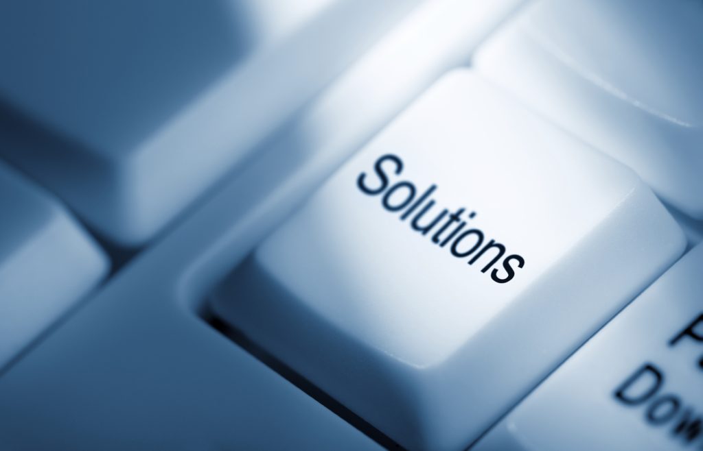 Image of a computer keyboard with a key that says Solutions.
